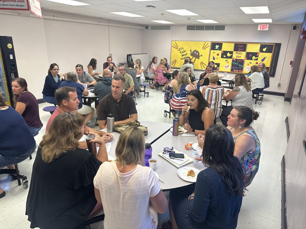 student gathers to eat breakfast and mingle in cafeteria