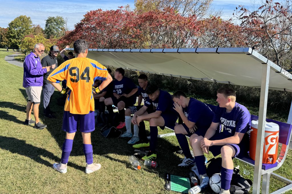 players sit on the new soccer field benches