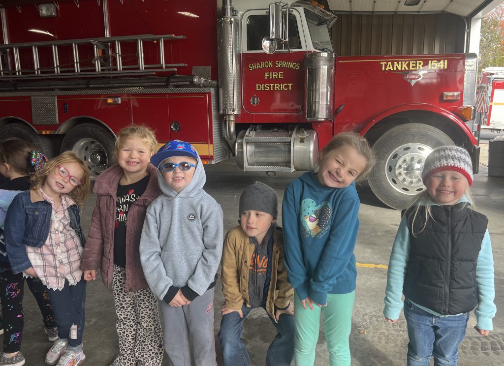 students gather in front of a fire truck