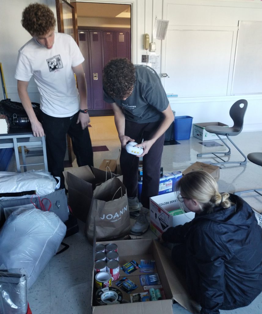 students sort through boxes of donations