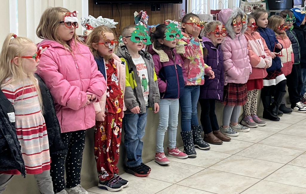 line of children with Christmas masks