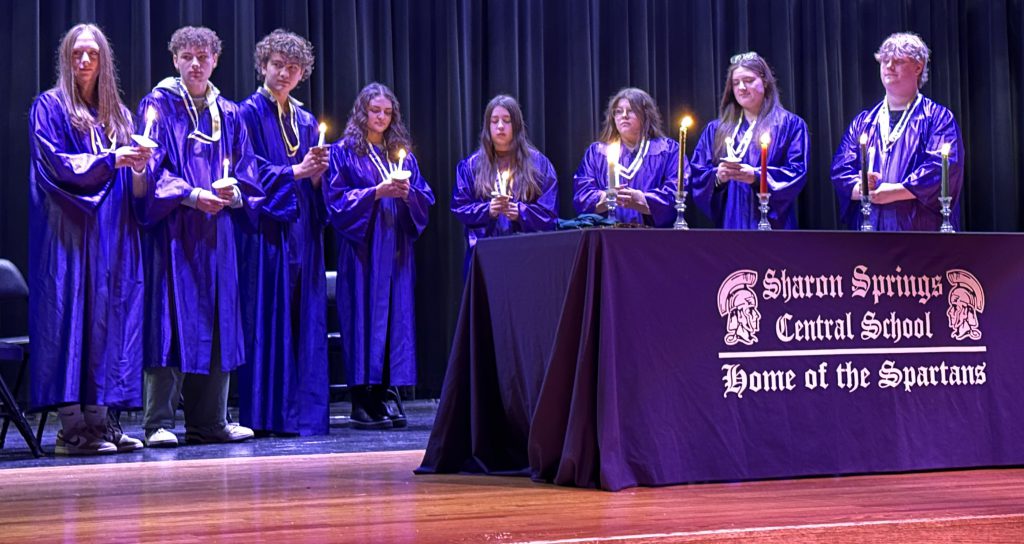 group of students with lit candles