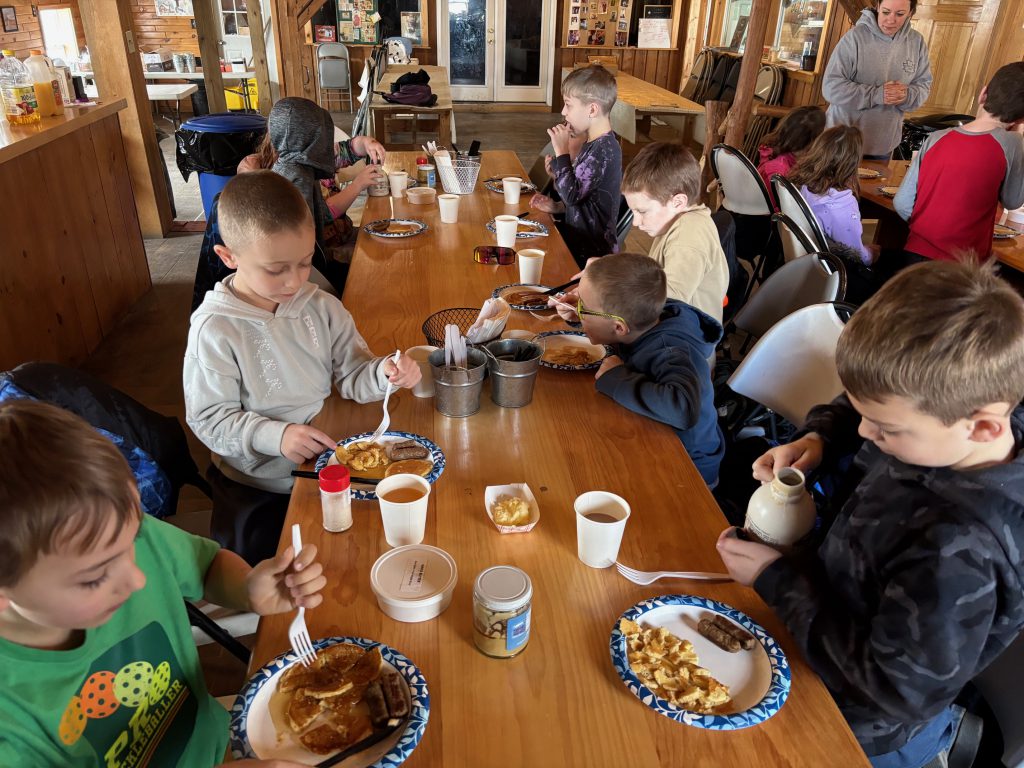 second graders enjoy a pancake breakfast